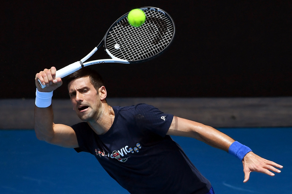 Novak Djokovic of Serbia hits a return during a practice session ahead of the Australian Open at the Melbourne Park tennis centre in Melbourne, January 12, 2022. u00e2u20acu201d AFP picn