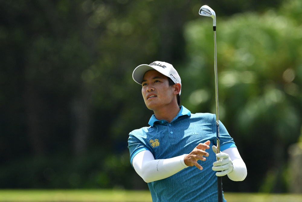 Rattanon Wannasrichan of Thailand playing a shot during round two of the Singapore International golf tournament in Singapore, January 14, 2022. u00e2u20acu201d Paul Lakatos/Asian Tour handout pic via AFPnn