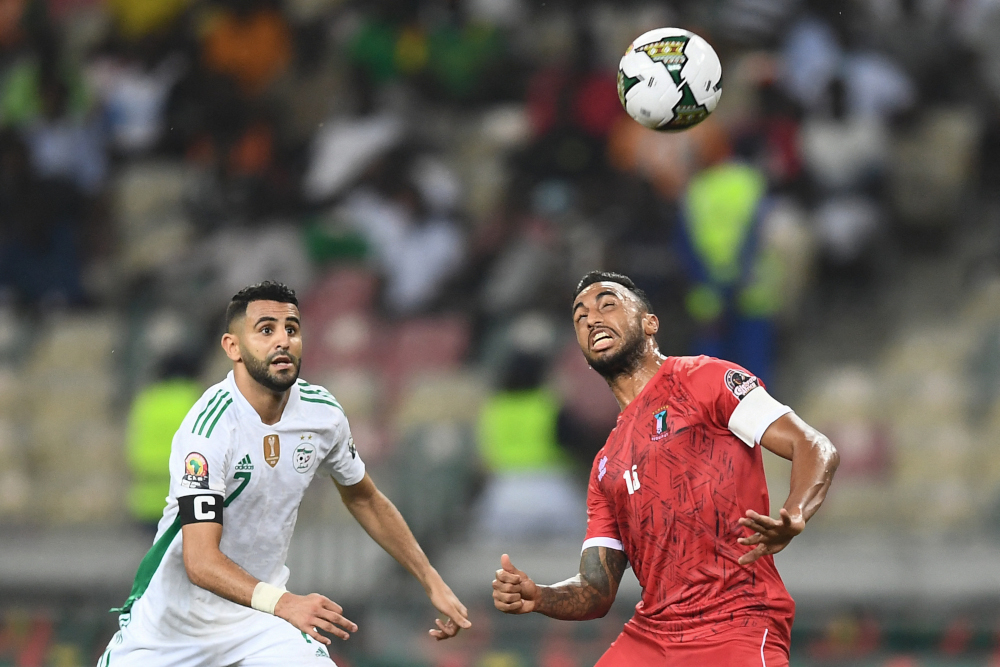 Algeriau00e2u20acu2122s forward Riyad Mahrez (left) vies with Equatorial Guineau00e2u20acu2122s defender Carlos Akapo during the Group E Africa Cup of Nations 2021 match at Stade de Japoma in Douala, January 16, 2022. u00e2u20acu201d AFP pic 