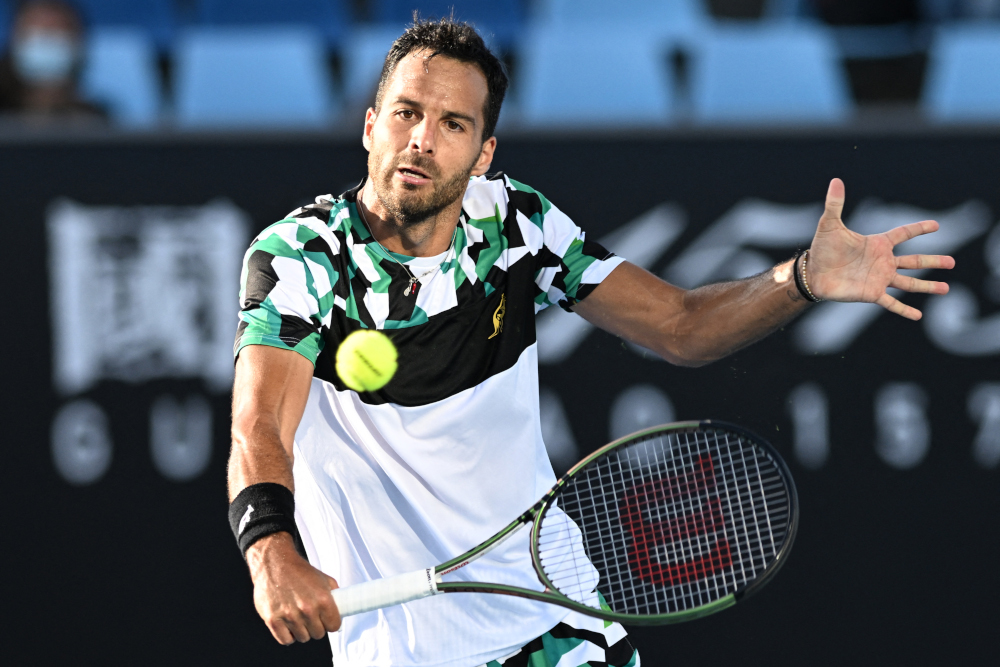 Italyu00e2u20acu2122s Salvatore Caruso hits a return against Serbiau00e2u20acu2122s Miomir Kecmanovic during their menu00e2u20acu2122s singles match on day one of the Australian Open tennis tournament in Melbourne, January 17, 2022. u00e2u20acu201d AFP pic 