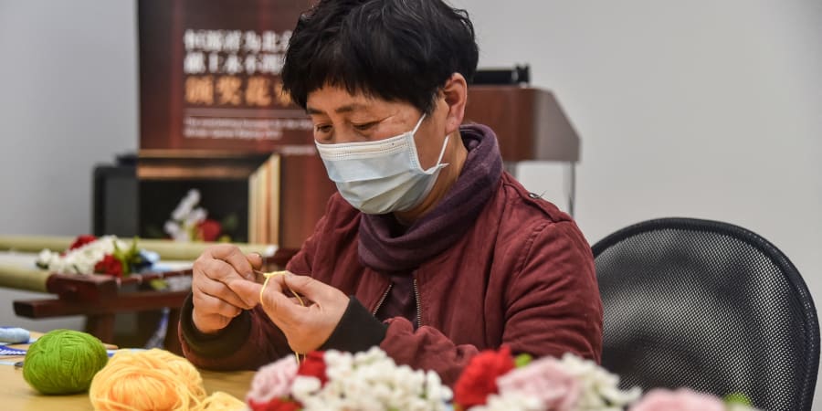 Li Meili, one of the designers of the hand-made medallist bouquets for the Beijing 2022 Olympic Games, shows how the bouquet is made in Shanghai. u00e2u20acu201d ETX Studio pic
