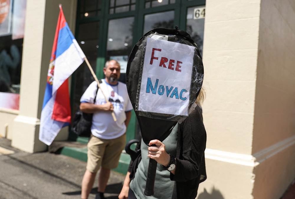 A supporter of Serbian tennis player Novak Djokovic holds up a sign outside the Park Hotel, where the star athlete is believed to be held while he stays in Australia, in Melbourne January 7, 2022. u00e2u20acu2022 Reuters pic