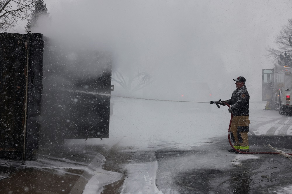 Jeff Held from the Westminster Fire Department puts out a fire in a shipping container that had been filled with storage items from the home that used to be there in Louisville, Colorado December 31, 2021. u00e2u20acu2022 Reuters pic
