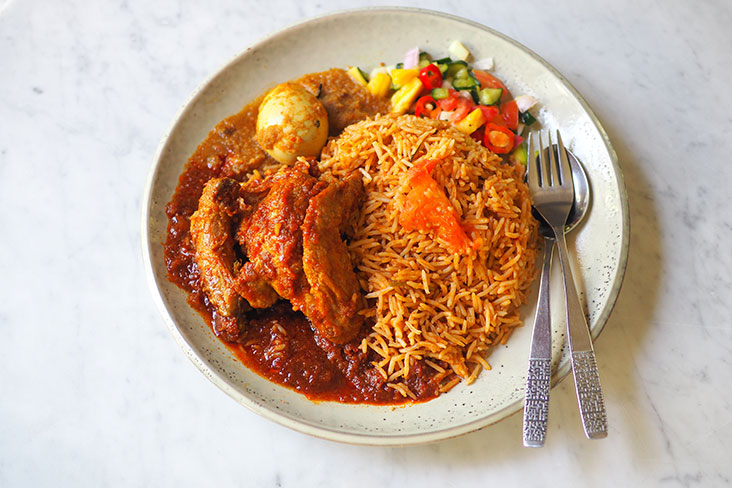 The 'nasi tomato' served with 'ayam masak merah' is a huge portion that can be easily divided into two meals for a small eater