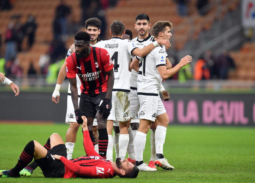 Spezia players celebrate scoring their second goal scored by Emmanuel Gyasi as AC Milanu00e2u20acu2122s Olivier Giroud reacts after sustaining an injury at San Siro, Milan, Italy, January 17, 2022. u00e2u20acu201d Reuters pic 