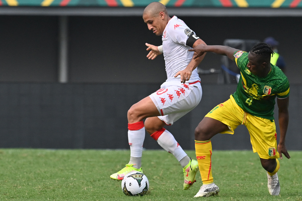 Tunisiau00e2u20acu2122s forward Wahbi Khazri (left) fights for the ball with Maliu00e2u20acu2122s midfielder Amadou Haidara during the Group F Africa Cup of Nations 2021 match at Limbe Omnisport Stadium in Limbe, January 12, 2022. u00e2u20acu201d AFP picnn