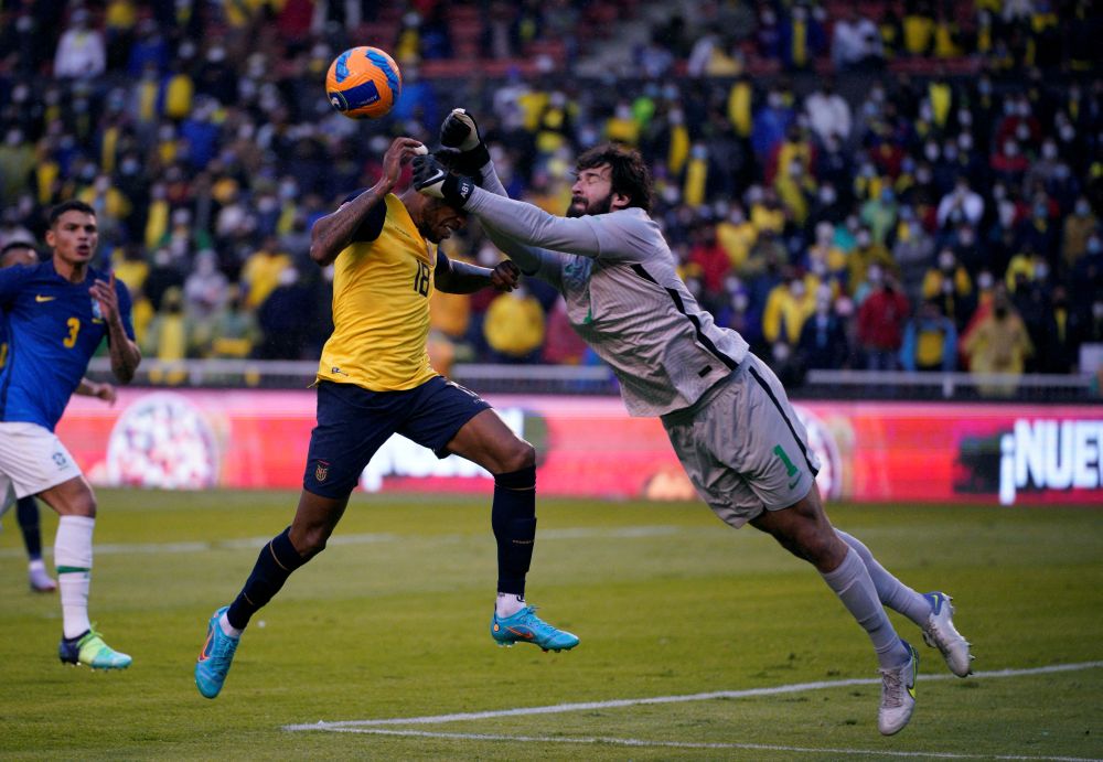 Brazil's Alisson in action with Ecuador's Ayrton Preciado at Estadio Rodrigo Paz Delgado, Quito January 27, 2022. u00e2u20acu201d Reuters pic