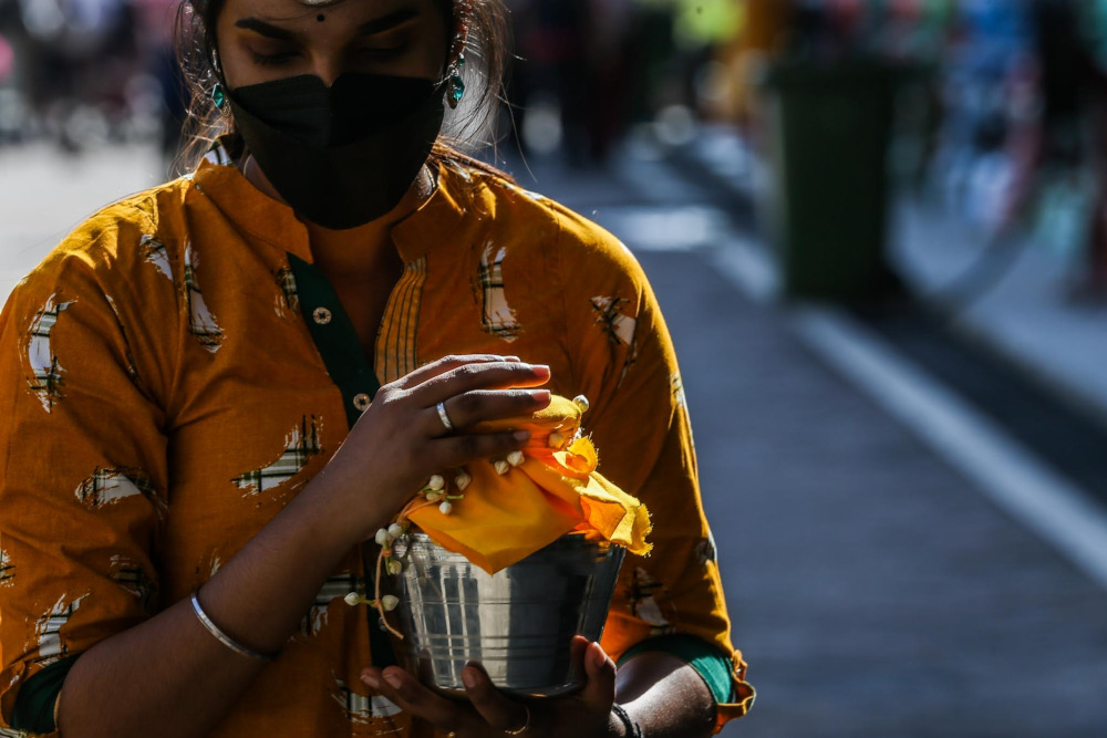 Malaysian Hindu devotees carry milk pots at Batu Caves, January 13, 2022. — Picture by Hari Anggara