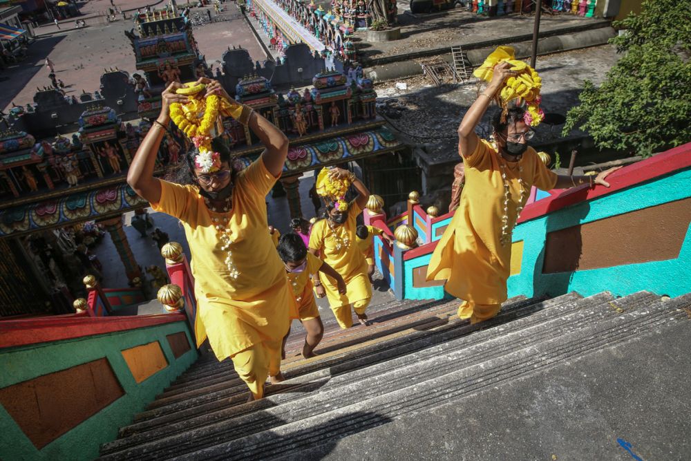 Hindu devotees carry offerings on their heads as they climb the steps to the Sri Subramaniam Temple in Batu Caves January 12, 2022. u00e2u20acu201d Picture by Yusof Mat Isan