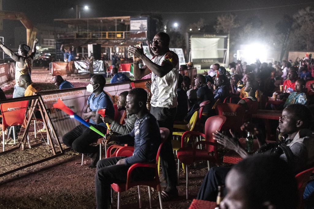 Burkina Faso supporters celebrate in Ouagadougou on January 29, 2022, as they watch on television their teamu00e2u20acu2122s victory in the Africa Cup of Nations 2021 quarter final match between Burkina Faso and Tunisia, played in Garoua, Cameroon. u00e2u20acu201d AFP pic