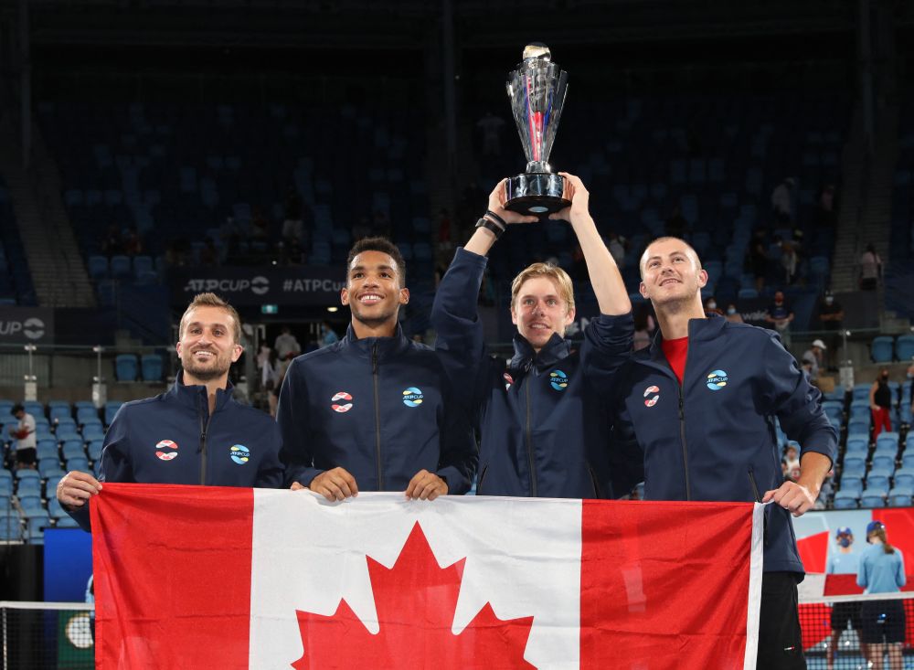 Canada's Steven Diez, Felix Auger-Aliassime, Denis Shapovalov and Brayden Schnur pose with the trophy and their national flag as they celebrate after winning the ATP Cup January 9, 2022. u00e2u20acu201d Reuters pic