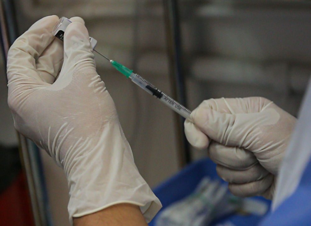 A nurse prepares the Covid-19 booster dose jab at the Perak Community Specialist Hospital (PCSH), January 5, 2022. u00e2u20acu201d Picture by Farhan Najib
