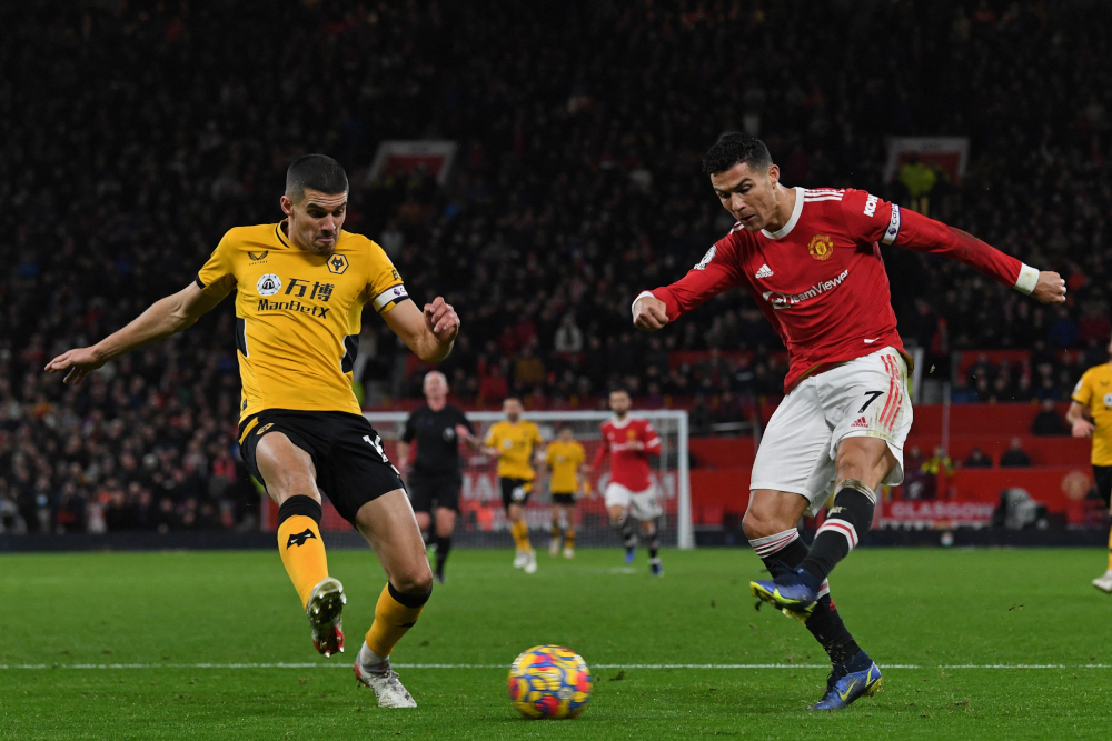 Manchester United striker Cristiano Ronaldo has an unsuccessful shot past Wolverhampton Wanderersu00e2u20acu2122 English defender Conor Coady at Old Trafford in Manchester, north-west England, January 3, 2022. u00e2u20acu201d AFP picnn