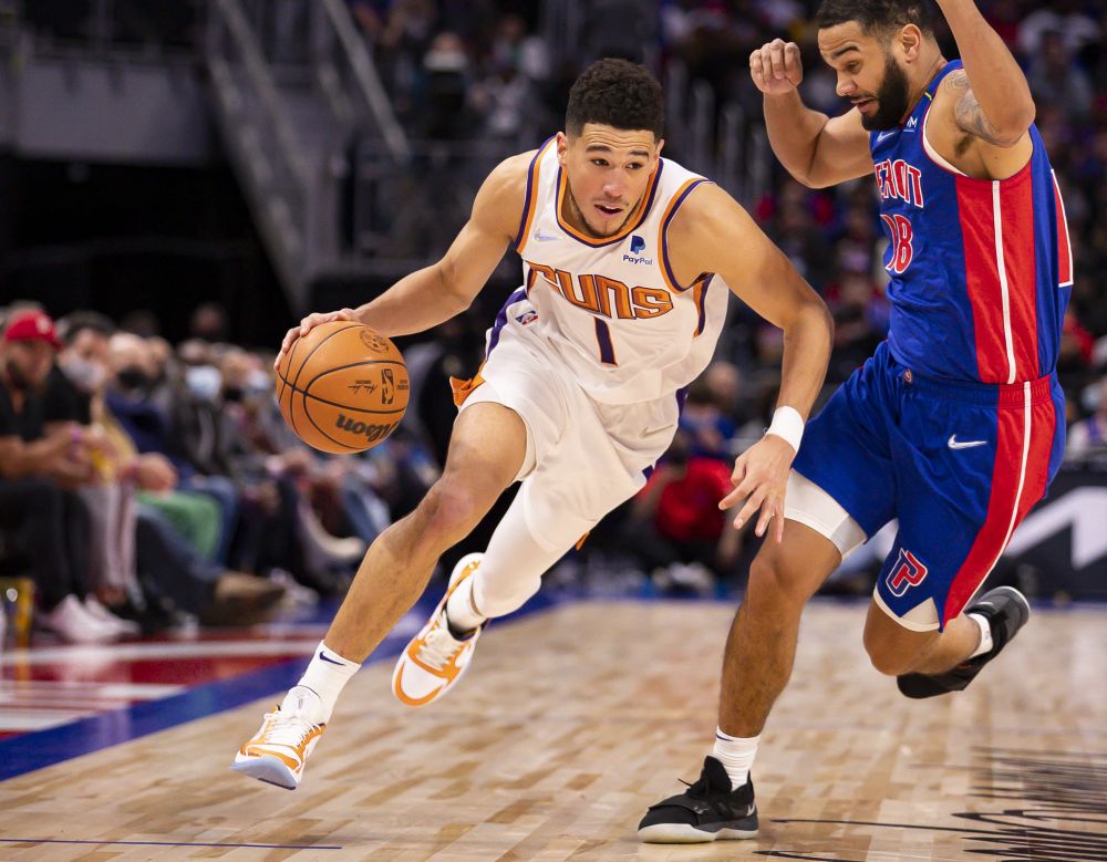 Phoenix Suns guard Devin Booker (1) gets defended by Detroit Pistons guard Cory Joseph (18) during the third quarter at Little Caesars Arena, Detroit January 16, 2022. u00e2u20acu201d Reuters pic