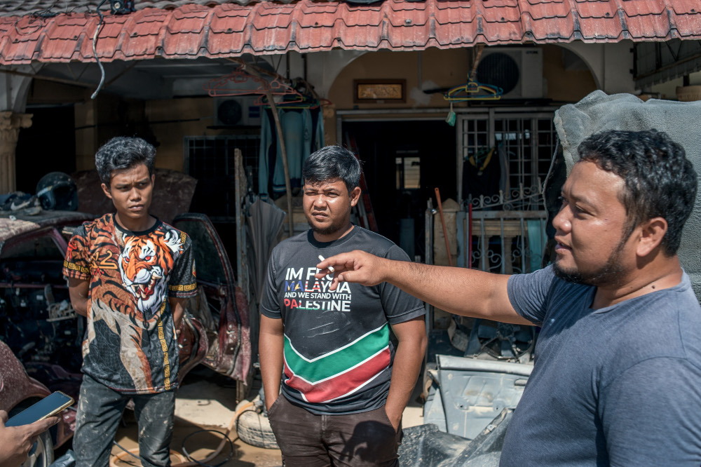(From left) Ashwath 21, Mohd Hafiz 32, and Amir Hamzah, 40, speak to Malay Mail during an interview in Taman Sri Nanding, Hulu Langat January 6, 2022. — Picture by Shafwan Zaidon