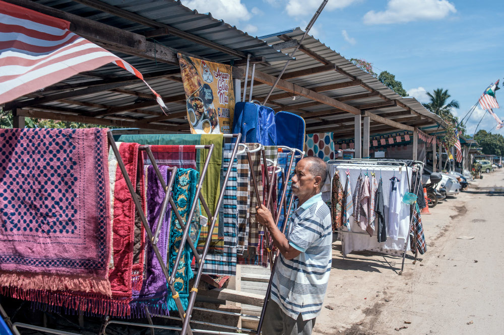 A man is seen putting laundry out to dry in Taman Sri Nanding, Hulu Langat January 6, 2022. — Picture by Shafwan Zaidon