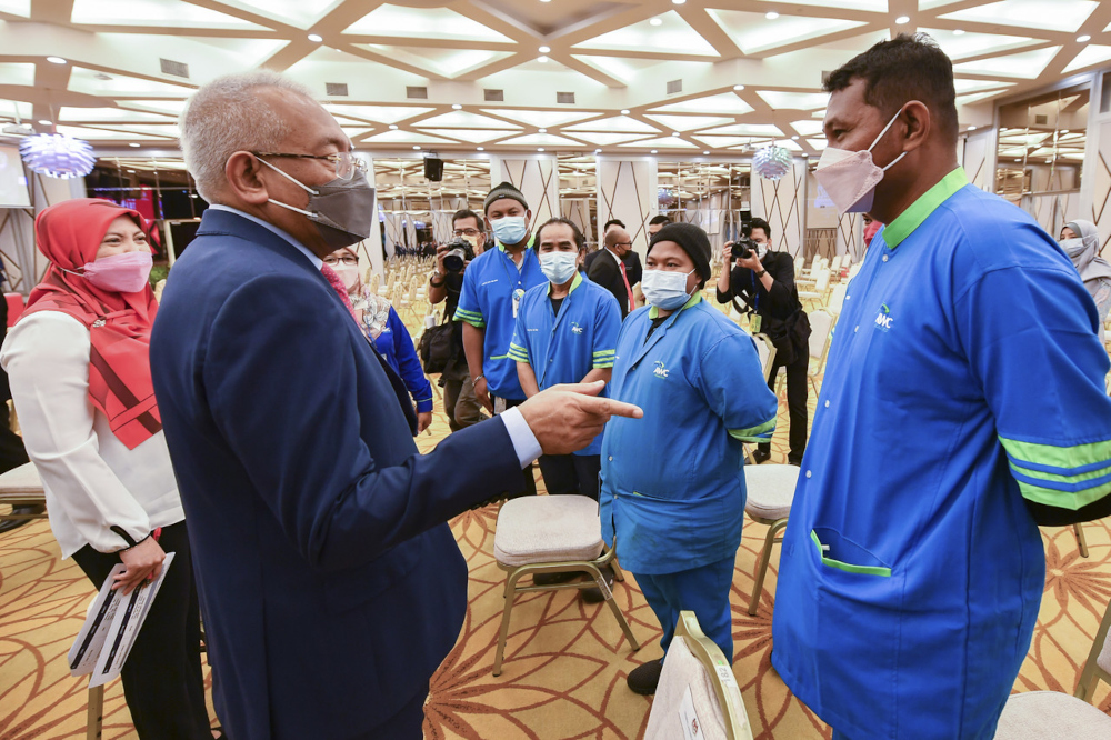 Rural Development Minister Datuk Seri Mahdzir Khalid speaks to cleaning personnel after delivering his New Year mandate to the ministry in Putrajaya, January 14, 2022. u00e2u20acu201d Bernama pic 