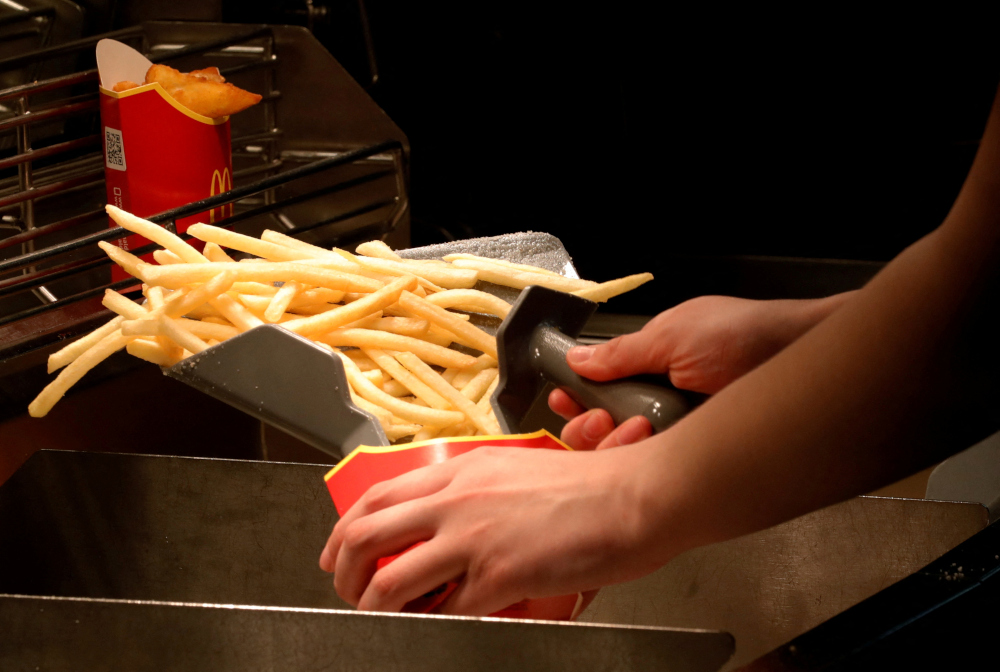 An employee cooks French fries at a McDonaldu00e2u20acu2122s restaurant in Moscow, Russia, April 24, 2018. u00e2u20acu201d Reuters pic 