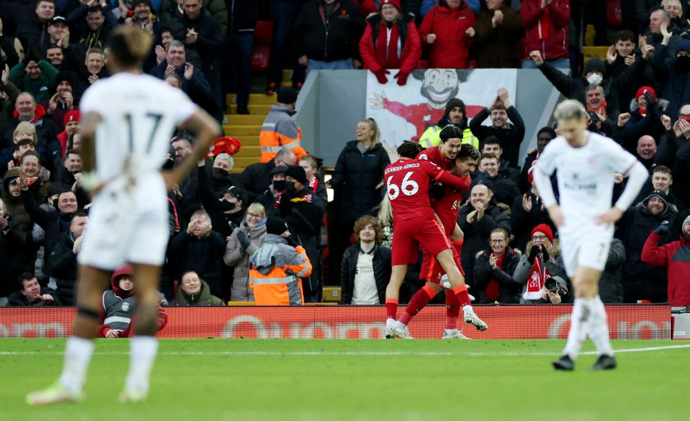 nLiverpool's Takumi Minamino celebrates scoring their third goal against Brentford with Roberto Firmino and Trent Alexander-Arnold at Anfield, Liverpool January 16, 2022. u00e2u20acu201d Reuters picn