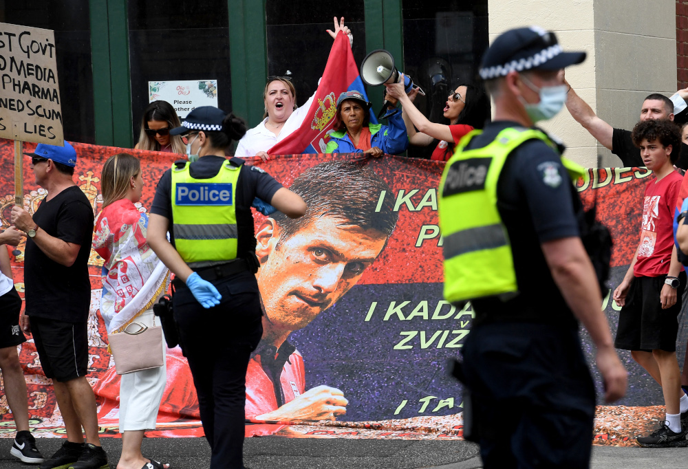 People hold placards at a government detention centre where Serbiau00e2u20acu2122s tennis champion Novak Djokovic is reported to be staying in Melbourne January 7, 2022. u00e2u20acu201d AFP pic 