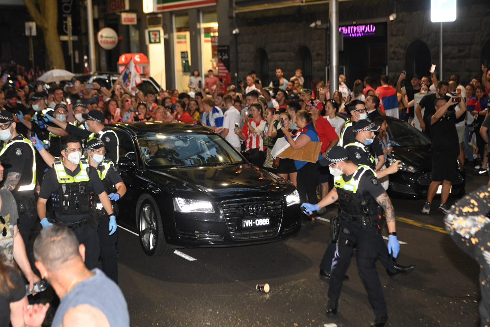 Police officers pepper spray supporters to clear a road for Serbiau00e2u20acu2122s tennis champion Novak Djokovicu00e2u20acu2122s car in Melbourne, January 9, 2022. u00e2u20acu201d AFP picn