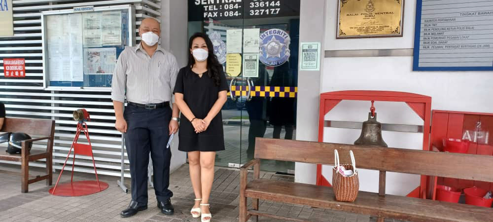 Lau and her brother Roger in front of the police station. u00e2u20acu201d Picture via Borneo Post
