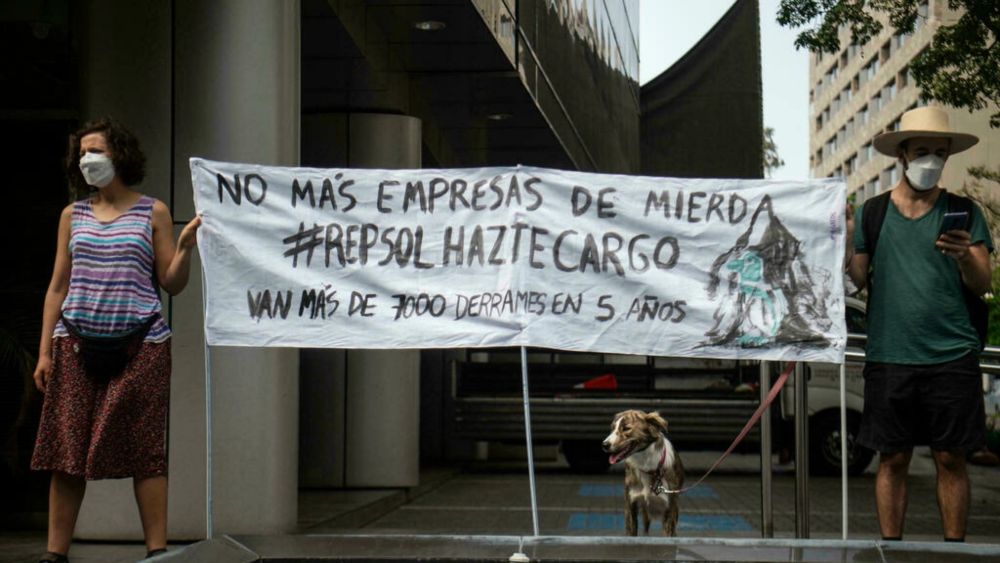 People take part in a demonstration against the Spanish oil company Repsol in Lima, on January 21, 2022 after the spill of some 6,000 barrels of crude oil. u00e2u20acu201d AFP pic