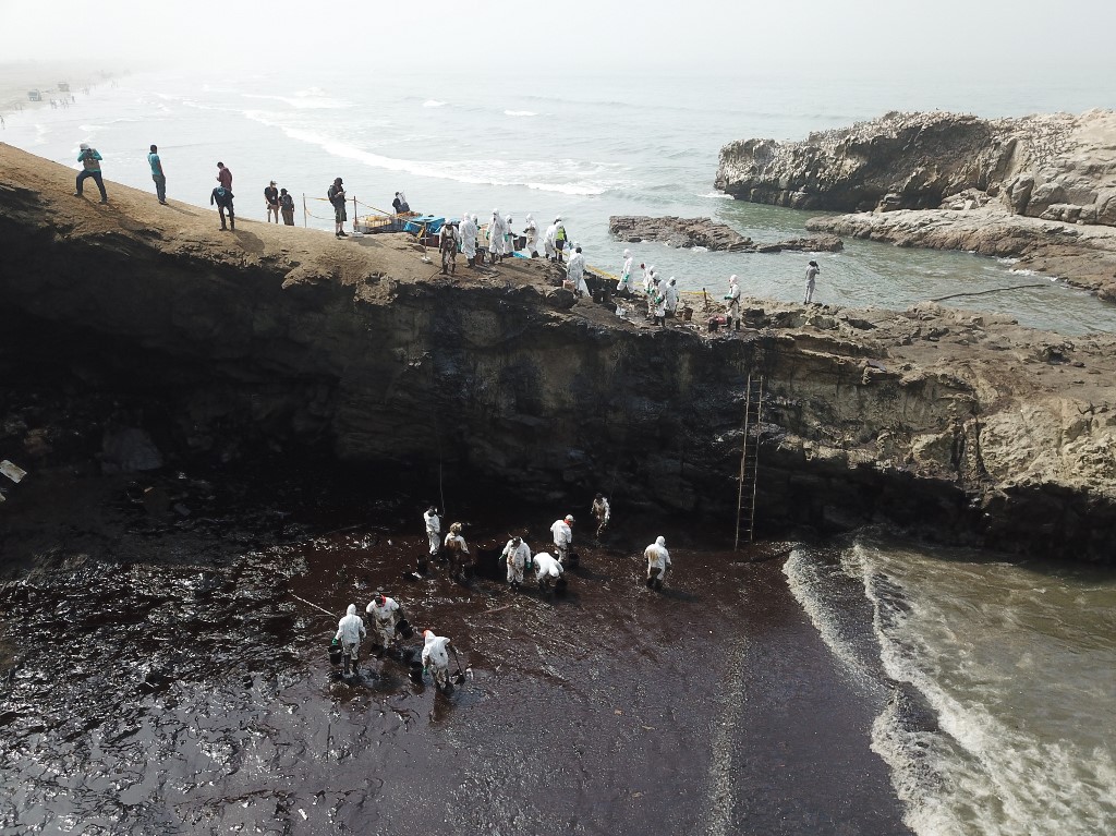 Aerial view of cleaning crews working to remove oil from a beach annexed to the summer resort town of Ancon, northern Lima, on January 22, 2022. u00e2u20acu201d AFP pic