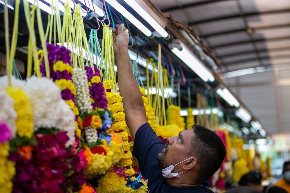 People shop for flower garlands ahead of Ponggal celebrations in Little India, Brickfields January 13, 2022. u00e2u20acu201d Picture by Devan Manuelnn
