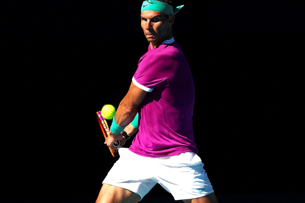 Spainu00e2u20acu2122s Rafael Nadal hits a return against Canadau00e2u20acu2122s Denis Shapovalov during their menu00e2u20acu2122s singles quarter-final match on day nine of the Australian Open tennis tournament in Melbourne on January 25, 2022. u00e2u20acu201d AFP picn