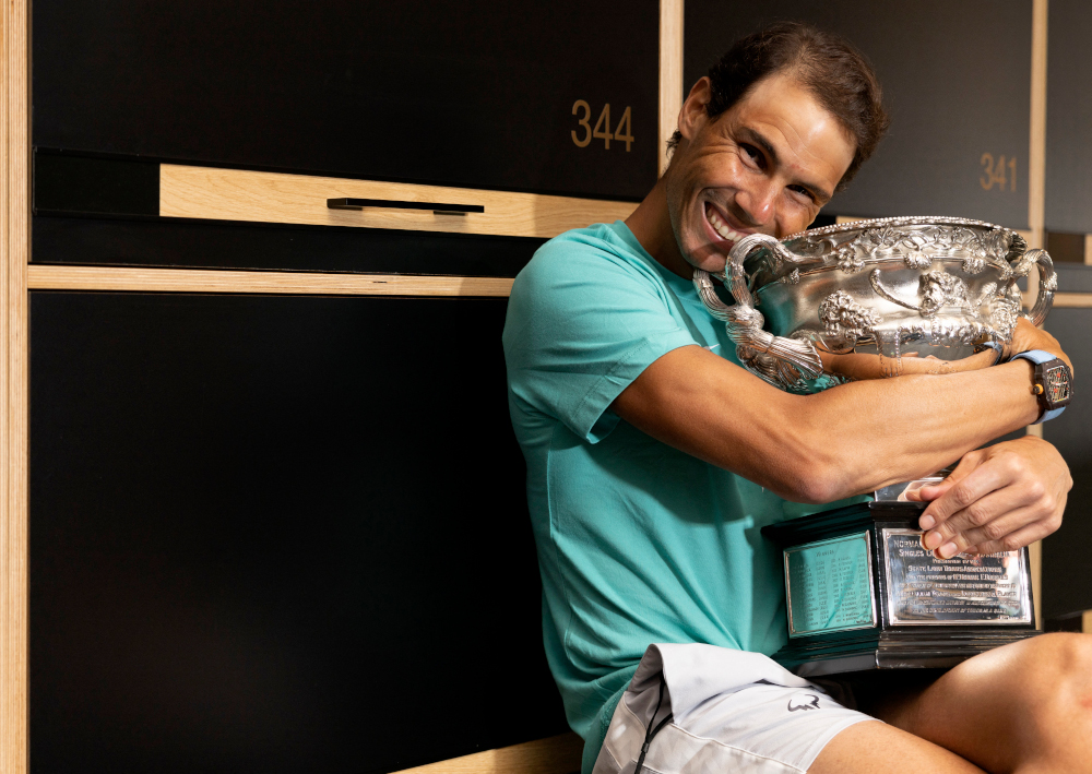 Spainu00e2u20acu2122s Rafael Nadal poses with Australian Open menu00e2u20acu2122s singles final trophy at the locker room in Melbourne, January 31, 2022. u00e2u20acu201d Tennis Australia handout pic via AFP 