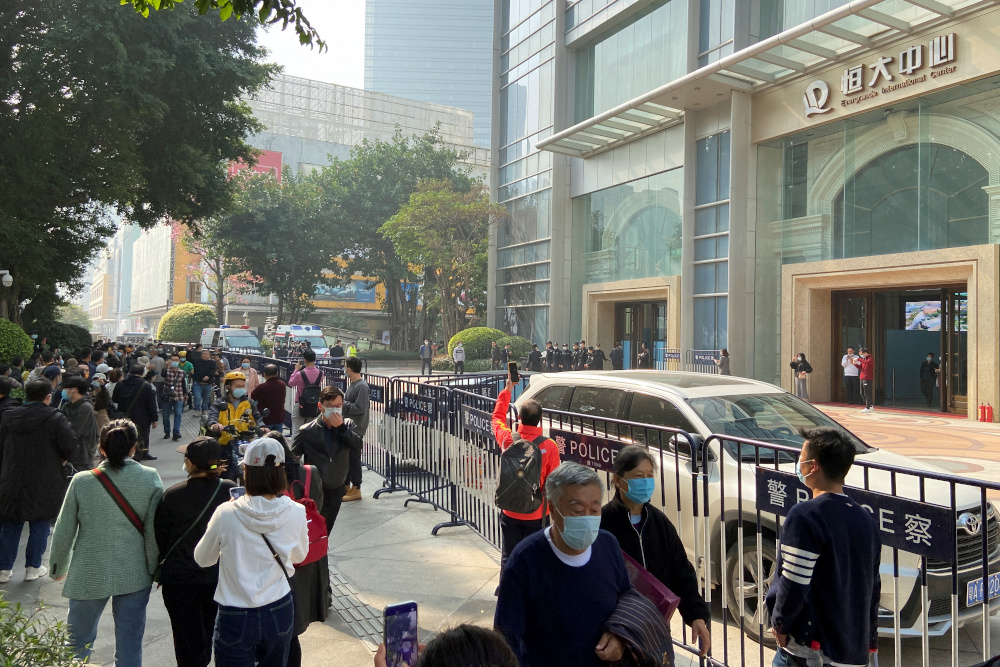 Protesters seeking payment from China Evergrande Group gather as police officers stand guard outside the Evergrande International Centre in Guangzhou, Guangdong province January 4, 2022. u00e2u20acu201d Reuters pic