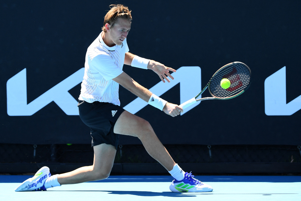 USAu00e2u20acu2122s Sebastian Korda hits a return against Franceu00e2u20acu2122s Corentin Moutet during their menu00e2u20acu2122s singles match on day three of the Australian Open tennis tournament in Melbourne, January 19, 2022. u00e2u20acu201d AFP picnn