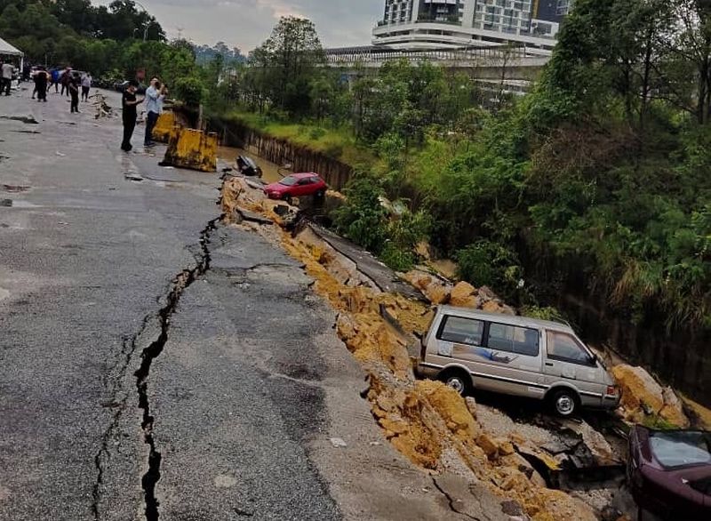 A part of the road in Lestari Perdana, Seri Kembangan collapsed yesterday following heavy rains. u00e2u20acu201d Picture via Facebook