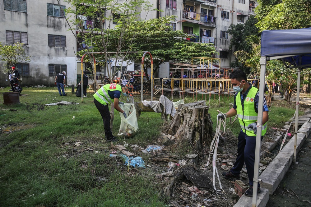 Workers clean up the area of Taman Sri Muda in Shah Alam January 8, 2022. u00e2u20acu2022 Picture by Yusof Mat Isa
