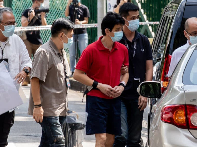 On January 27, 2022, Xavier Yap Jung Houn (third from left) was taken to the scene where the bodies of his two sons were found. u00e2u20acu201d TODAY picnn