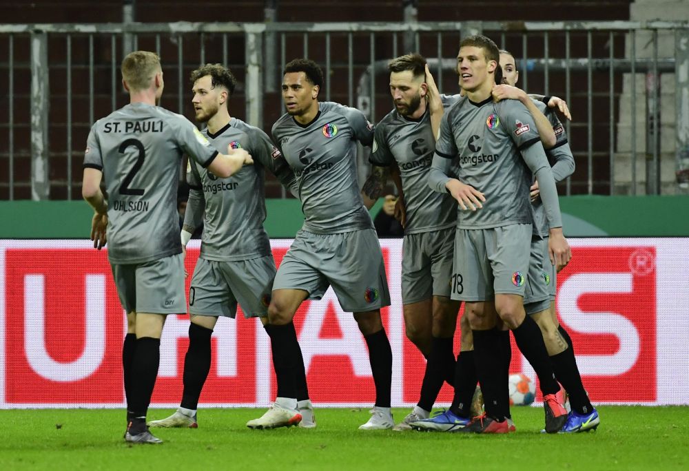 FC St Pauli players celebrate after Borussia Dortmund's Axel Witsel scores an own goal during the DFB Cup at the Millerntor-Stadion, Hamburg January 18, 2022. u00e2u20acu201d Reuters  pic