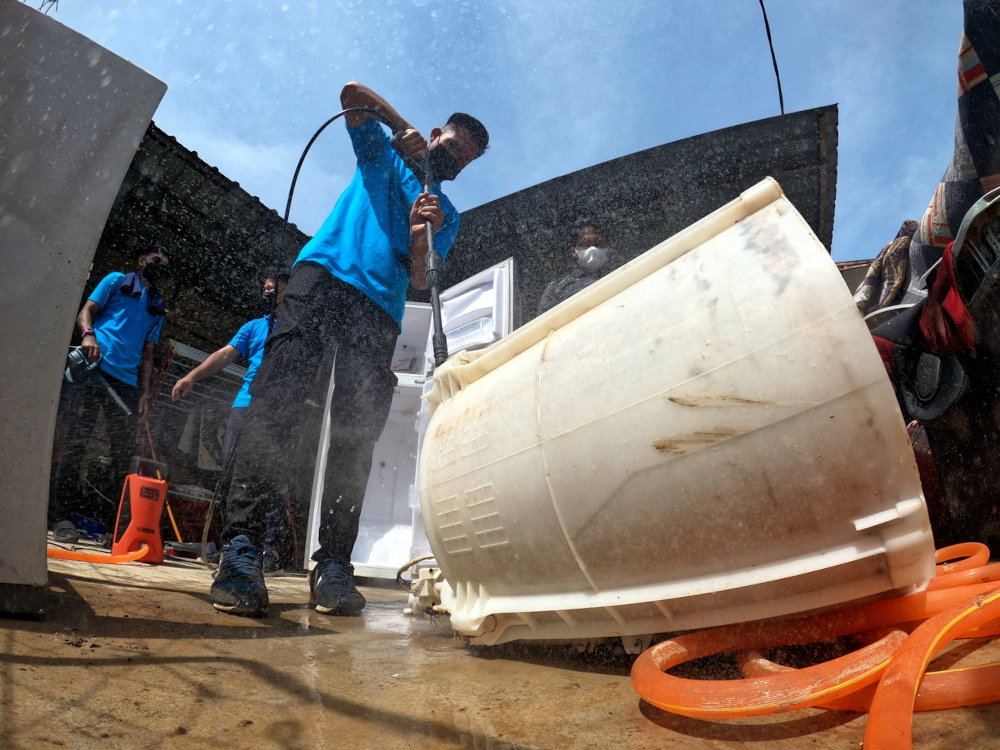 Volunteers from Industrial Training Institute repair electrical equipment after the floods in Taman Sri Nanding, Hulu Langat, January 10, 2022. u00e2u20acu201d Bernama pic 
