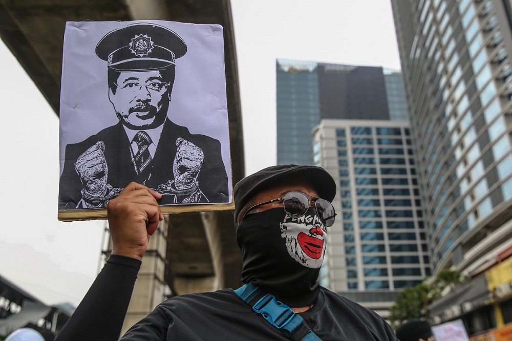 Protesters hold placards during the #TangkapAzamBaki rally in Kuala Lumpur January 22, 2022. u00e2u20acu2022 Picture by Yusof Mat Isa