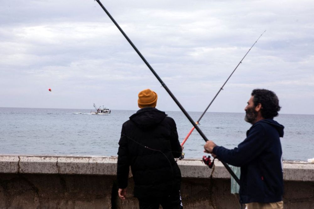 Israeli fishermen stand by the shore of the Mediterranean Sea following rockets fired by Palestinian militants in Gaza, causing an explosion off the shore of Tel Aviv, according to Israelu00e2u20acu2122s military, in Tel Aviv, Israel January 1, 2022. u00e2u20acu201d Reuters pic