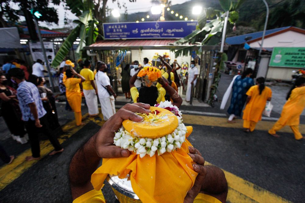 Hindu devotees carry offerings on their heads as they make their way to the Hilltop Murugan Temple in George Town during Thaipusam January 18, 2022. u00e2u20acu201d Picture by Sayuti Zainudin