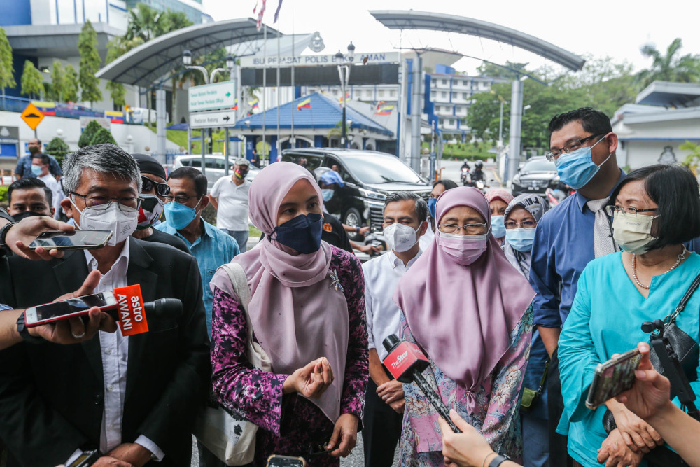 Former deputy prime minister Datuk Seri Dr Wan Azizah Wan Ismail and Permatang Pauh MP Nurul Izzah Anwar speak to reporters outside Bukit Aman police headquarters, January 28, 2022. u00e2u20acu201d Picture by Hari Anggara