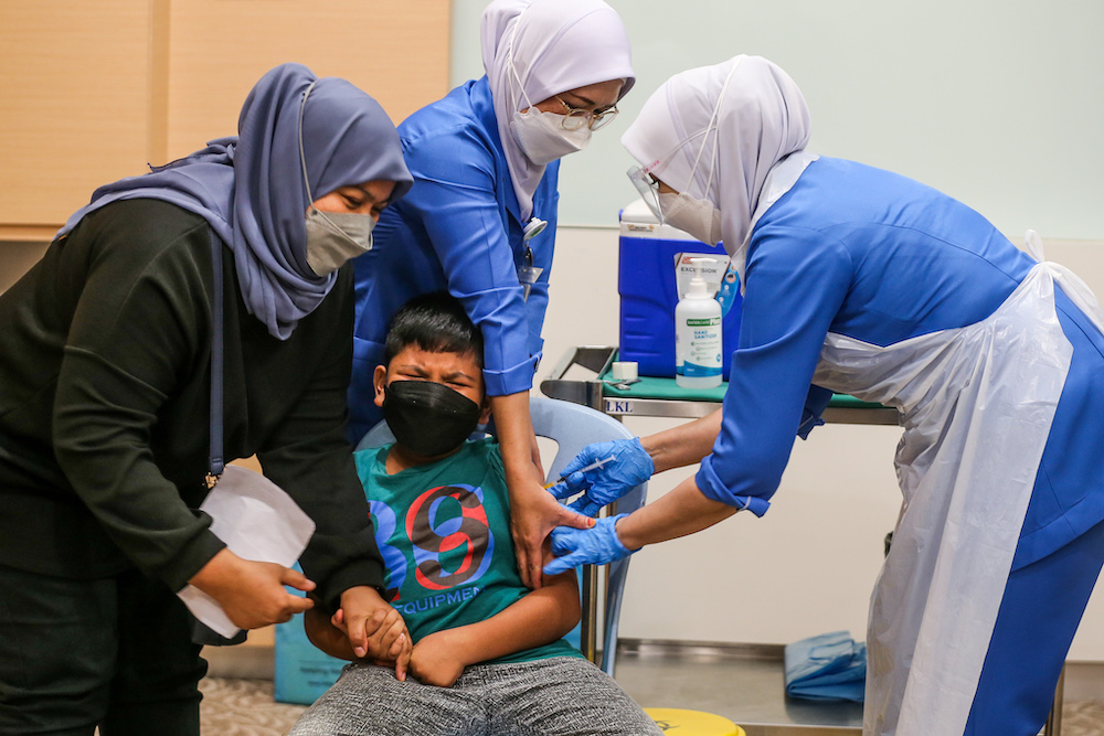A child receives gets vaccinated with the Pfizer Covid-19 vaccine during the PICKids program at Hospital Tunku Azizah in Kuala Lumpur February 3,2022. u00e2u20acu201d Picture by Ahmad Zamzahuri