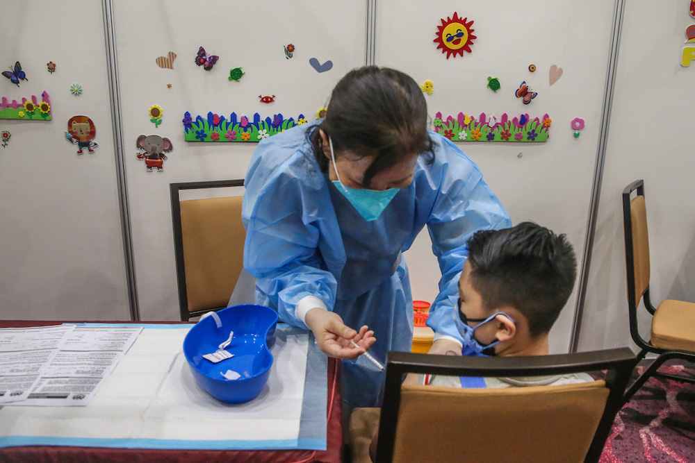 A child gets his Covid-19 vaccine during the National Covid-19 Immunisation Programme for Kids (PICKids) at Ideal Convention Centre (IDCC) in Shah Alam January 3, 2022. u00e2u20acu201d Picture by Yusof Mat Isa