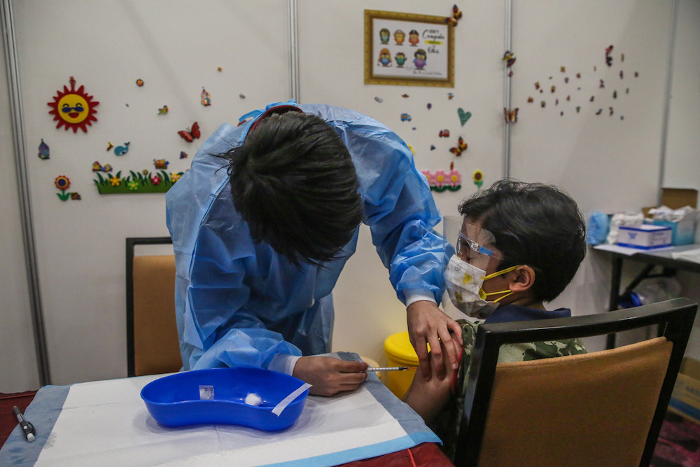 A child gets his Covid-19 vaccine during the National Covid-19 Immunisation Programme for Kids (PICKids) at Ideal Convention Centre (IDCC) in Shah Alam January 3, 2022. u00e2u20acu201d Picture by Yusof Mat Isa