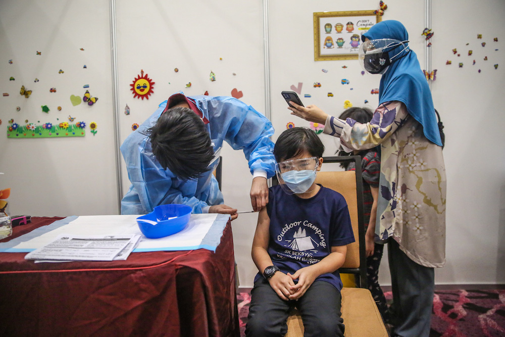 A child gets his Covid-19 vaccine during the National Covid-19 Immunisation Programme for Kids (PICKids) at Ideal Convention Centre (IDCC) in Shah Alam January 3, 2022. u00e2u20acu201d Picture by Yusof Mat Isa