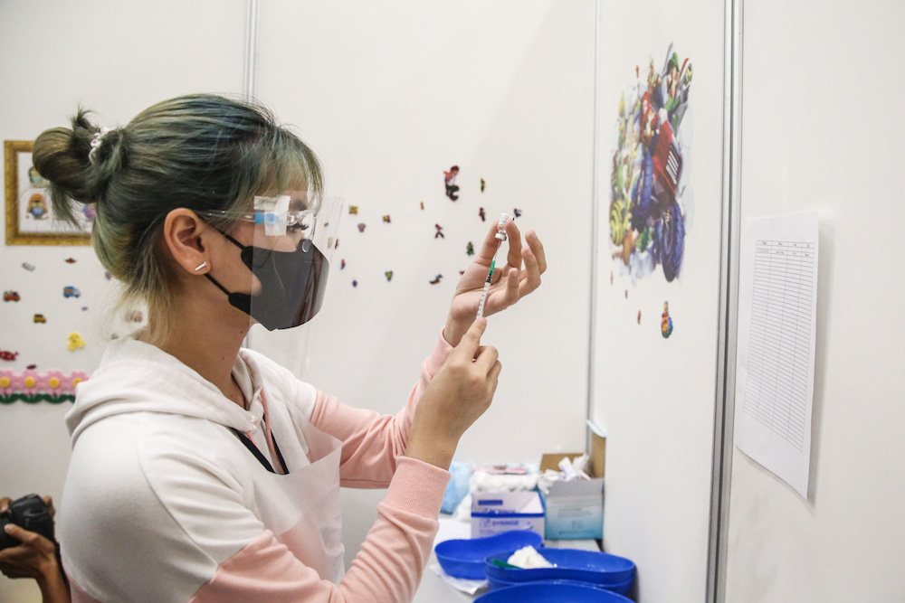 A medical worker prepares a dose of Covid-19 Pfizer-BioTech vaccine during the National Covid-19 Immunisation Programme for Kids (PICKids) at Ideal Convention Centre (IDCC) in Shah Alam January 3, 2022. u00e2u20acu201d Picture by Yusof Mat Isa