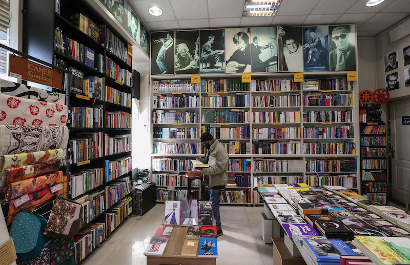 An Iranian man browses books at a library in Tehran January 29, 2022. u00e2u20acu201d AFP pic