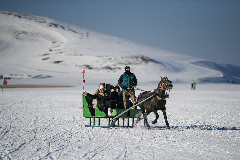 Orhan Goller, drives his horse cart on the ice of Cildir Lake at Cildir District, in Kars January 8, 2022. u00e2u20acu201d AFP pic
