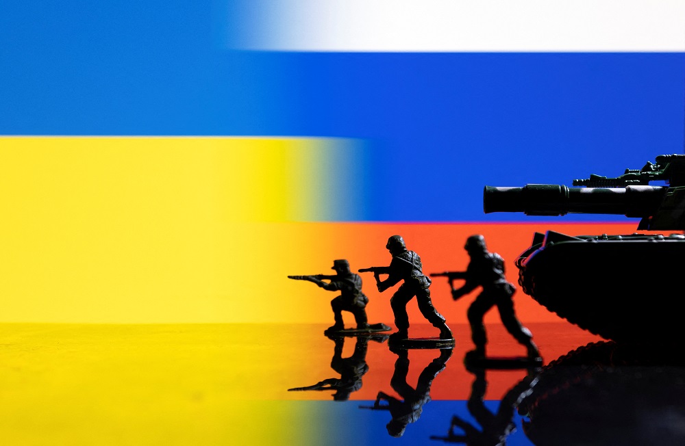 Army soldier figurines are displayed in front of the Ukrainian and Russian flag colours background in this illustration taken February 13, 2022. u00e2u20acu201d Reuters pic